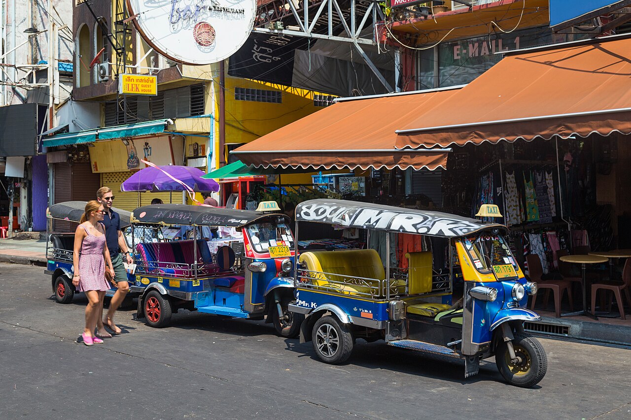 Tuk-tuks lined up waiting for tourists on Khao San Road in Bangkok, where opening quotes of 150 to 300 baht are three times the metered taxi fare on a cheap travel Thailand budget