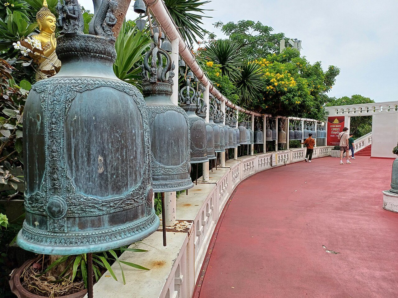 Visitors climbing the bell-lined ramp at Wat Saket, the Golden Mount in Bangkok, a 100-baht entry that is among the best value Thailand travel costs in the old town