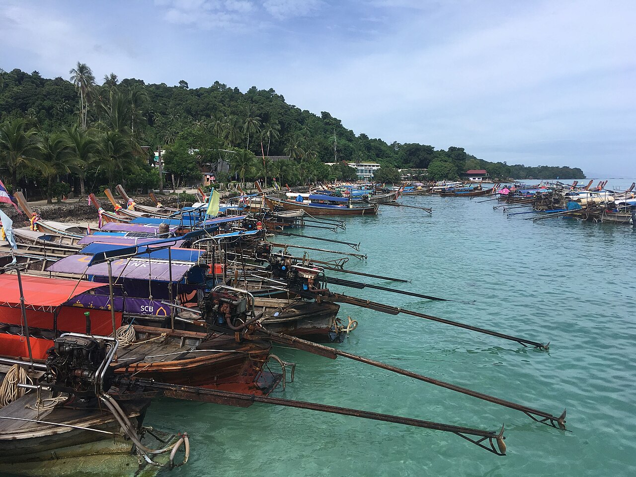 Long-tail boats moored off Tonsai Pier on Koh Phi Phi Don, chartered for 600 to 800 baht per boat to Maya Bay, one of the best cheap travel Thailand savings on the island
