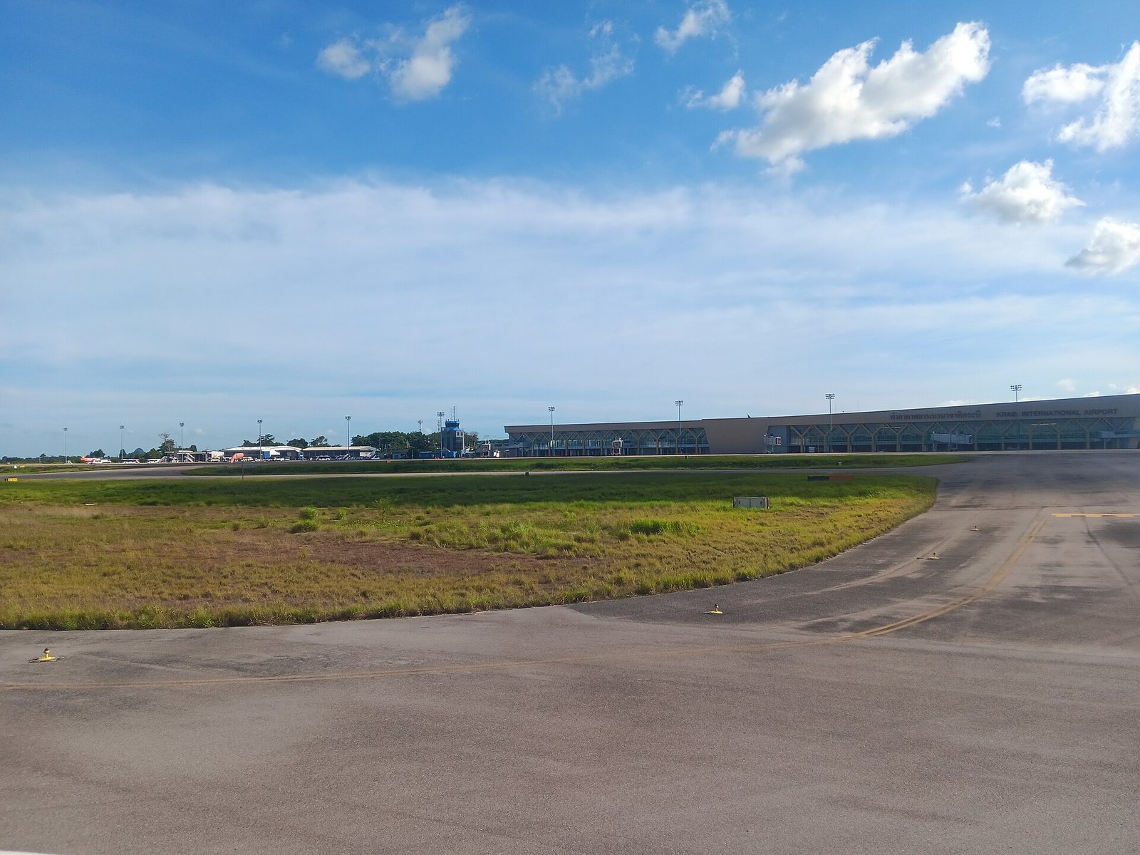 Krabi International Airport terminal building in Thailand, the arrivals hall where the 150-baht Ao Nang shuttle bus and the 1,500-baht taxi voucher are sold side by side
