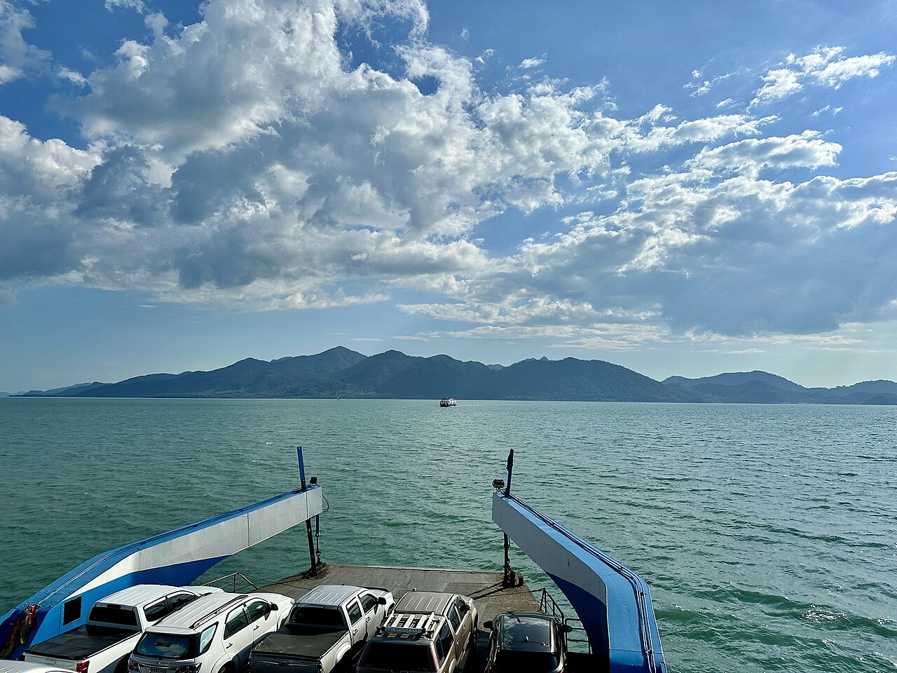 The vehicle deck of the Koh Chang ferry crossing from Ao Thammachat pier in Trat, Thailand, with cars aboard and the island ahead, the 90-baht crossing at the heart of Thailand budget travel to Koh Chang