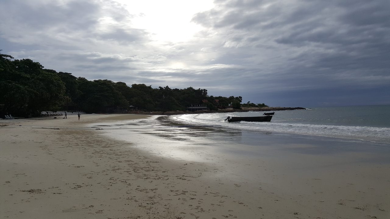 Wong Duean beach on Koh Samet at dawn with a longtail boat on the sand, the national park shoreline that the 200-baht foreigner entrance fee covers on a cheap travel Thailand beach trip