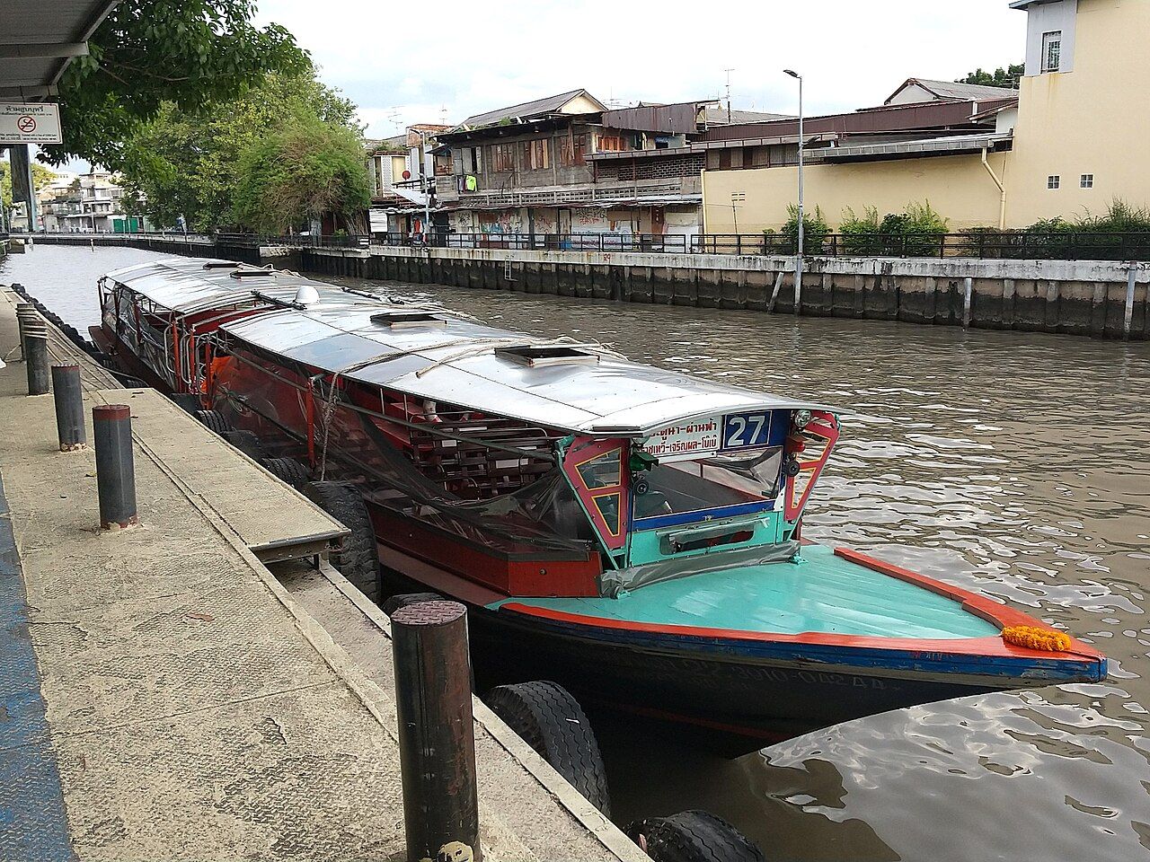 Khlong Saen Saep express boat number 27 moored at Panfa Leelard Pier in Bangkok, the 15-baht canal service used for Thailand budget travel